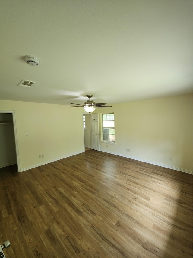 1721 Monaco Dr, Arlington, TX 76010 - spare room featuring dark wood-style flooring, a smoke detector, and ceiling fan