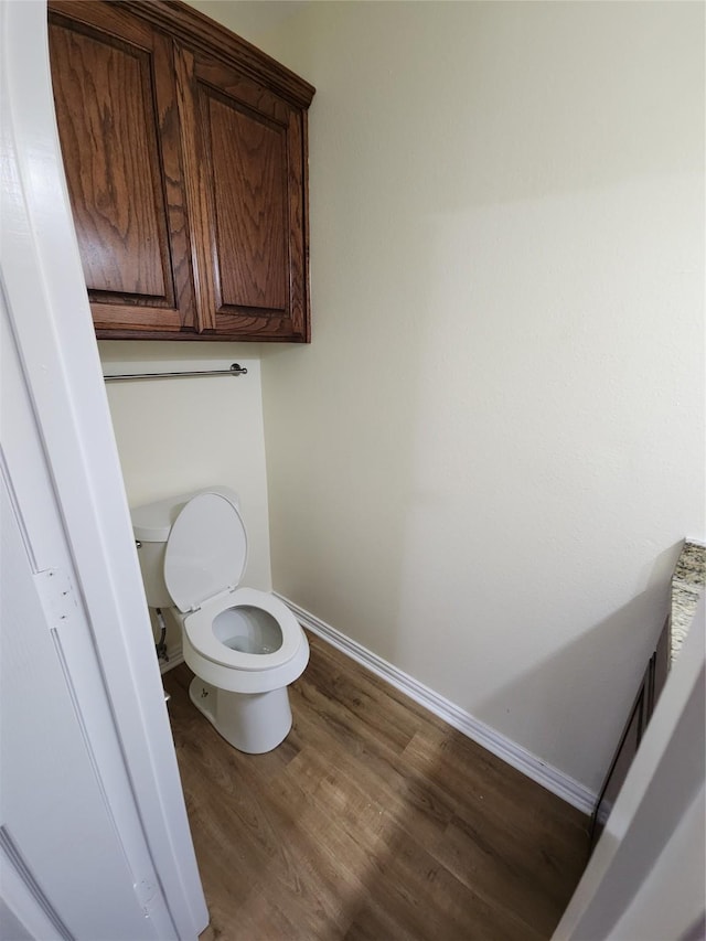 1721 Monaco Dr, Arlington, TX 76010 - bathroom with toilet and wood finished floors