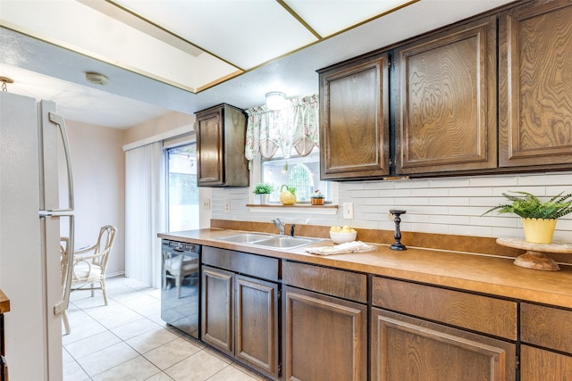 9662 Bryson Dr Unit A, Dallas, TX 75238 - kitchen featuring freestanding refrigerator, light tile patterned floors, dishwasher, light countertops, and backsplash