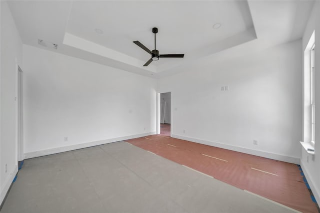 14017 Cimarron Dr, Balch Springs, TX 75180 - empty room with a raised ceiling, a ceiling fan, and concrete flooring