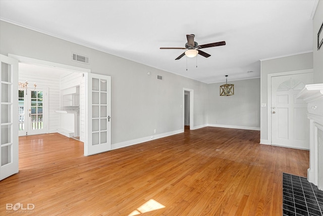 174 Carrollton Ave, Shreveport, LA 71105 - unfurnished living room with ceiling fan, light wood-type flooring, crown molding, french doors, and a chandelier