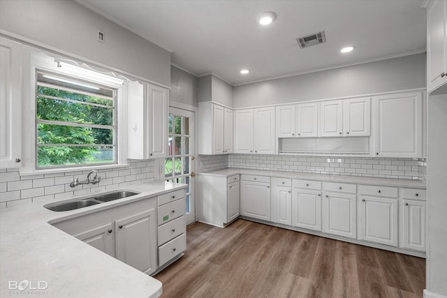 174 Carrollton Ave, Shreveport, LA 71105 - kitchen featuring light countertops, white cabinetry, tasteful backsplash, and recessed lighting