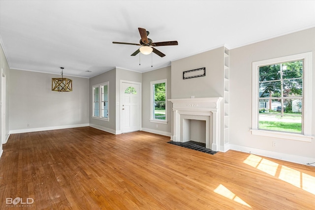 174 Carrollton Ave, Shreveport, LA 71105 - unfurnished living room featuring a ceiling fan, wood finished floors, crown molding, and a fireplace with flush hearth