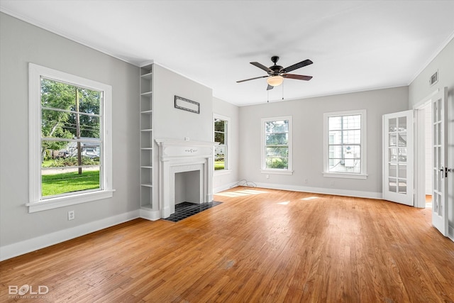 174 Carrollton Ave, Shreveport, LA 71105 - unfurnished living room featuring a fireplace with flush hearth, light wood-style floors, a ceiling fan, and crown molding
