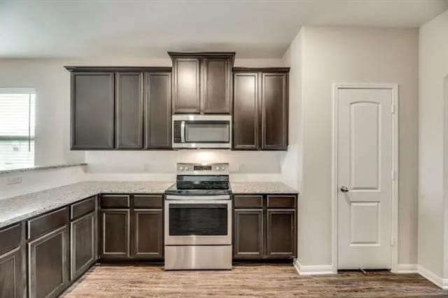 220 Aaron St, Anna, TX 75409 - kitchen featuring stainless steel appliances, light wood-style floors, and dark brown cabinets
