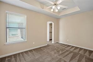 5729 Blackmon Ct, Fort Worth, TX 76137 - spare room featuring carpet floors, ceiling fan, arched walkways, and a raised ceiling