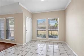 5729 Blackmon Ct, Fort Worth, TX 76137 - entryway featuring ornamental molding and light tile patterned floors