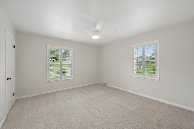 2705 Shelby St, Garland, TX 75041 - spare room with a ceiling fan, healthy amount of natural light, and light colored carpet