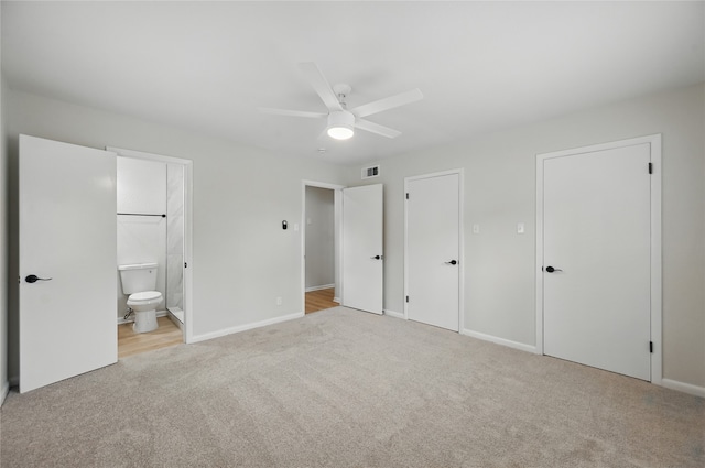 2705 Shelby St, Garland, TX 75041 - unfurnished bedroom with light colored carpet, connected bathroom, ceiling fan, and two closets