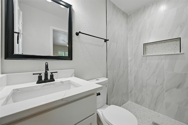 2705 Shelby St, Garland, TX 75041 - full bath featuring vanity, a textured wall, and a tile shower