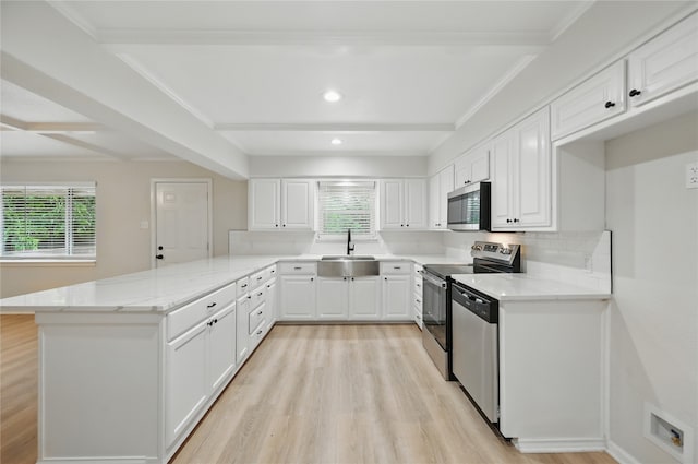 2705 Shelby St, Garland, TX 75041 - kitchen with stainless steel appliances, a peninsula, light wood-type flooring, healthy amount of natural light, and beamed ceiling