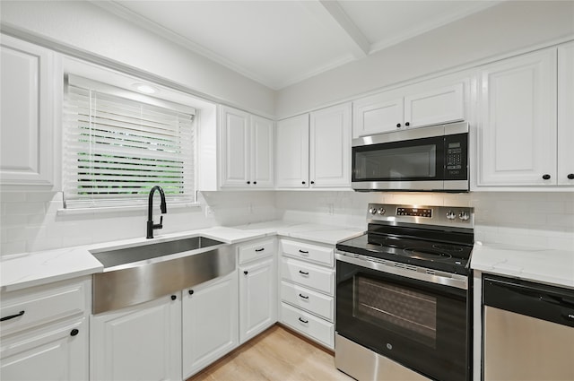 2705 Shelby St, Garland, TX 75041 - kitchen with stainless steel appliances, white cabinets, tasteful backsplash, light stone counters, and ornamental molding