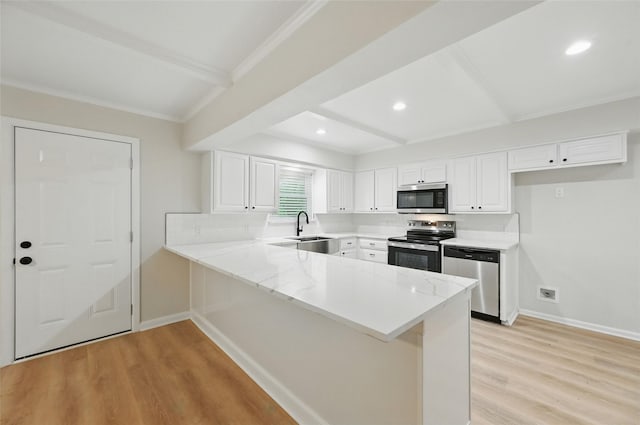 2705 Shelby St, Garland, TX 75041 - kitchen with stainless steel appliances, beam ceiling, light wood-style floors, a peninsula, and white cabinetry