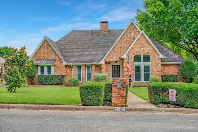 2900 Trail Lake Dr, Grapevine, TX 76051 - view of front facade with brick siding, a chimney, and a front lawn