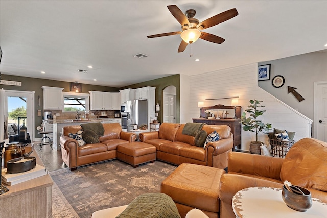 5885 State Highway 160, Whitewright, TX 75491 - living room featuring a ceiling fan, arched walkways, recessed lighting, dark wood-style flooring, and wood walls