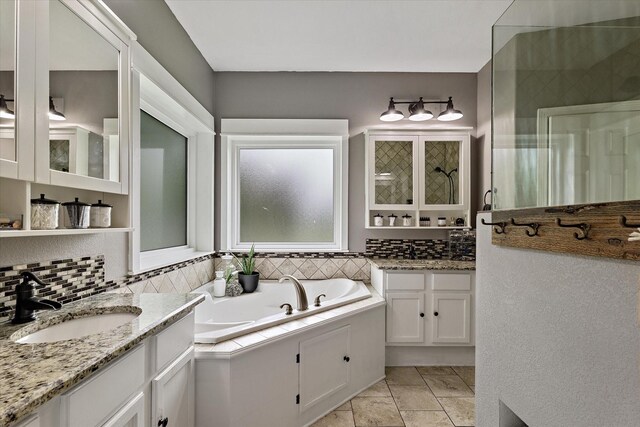5885 State Highway 160, Whitewright, TX 75491 - bathroom with backsplash, a garden tub, and two vanities