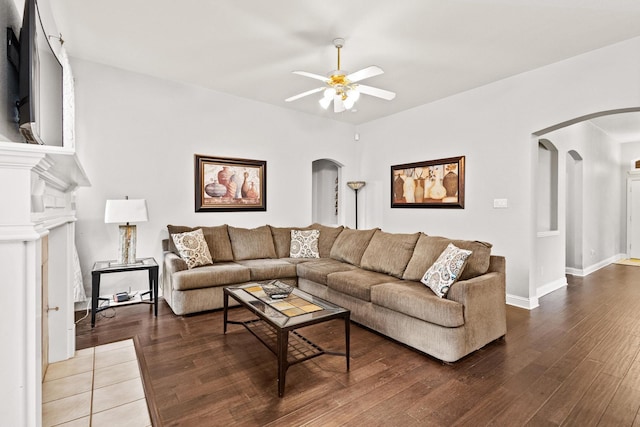2009 Lake Fork Ct, Denton, TX 76210 - living room with arched walkways, ceiling fan, wood finished floors, and a fireplace with flush hearth