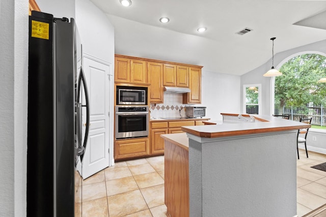2009 Lake Fork Ct, Denton, TX 76210 - kitchen featuring stainless steel appliances, under cabinet range hood, backsplash, light countertops, and light tile patterned floors