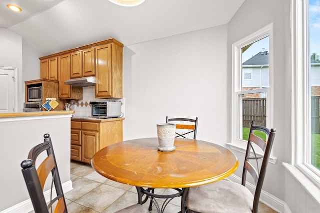 2009 Lake Fork Ct, Denton, TX 76210 - dining area featuring light tile patterned floors and lofted ceiling