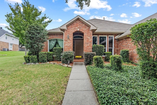 2009 Lake Fork Ct, Denton, TX 76210 - view of front of property featuring brick siding, a front lawn, and roof with shingles