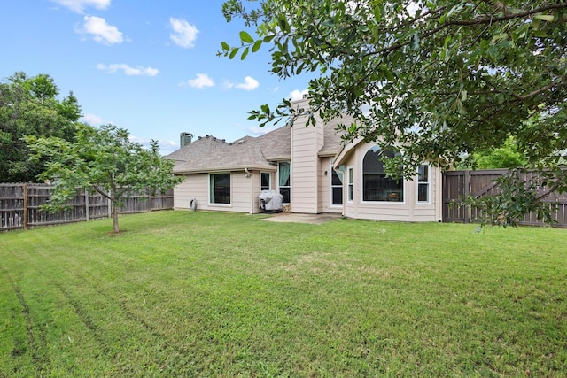 2009 Lake Fork Ct, Denton, TX 76210 - rear view of property with a fenced backyard, a chimney, and a patio