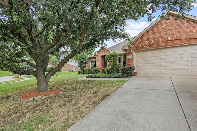2009 Lake Fork Ct, Denton, TX 76210 - view of front facade with brick siding, a front yard, driveway, and an attached garage