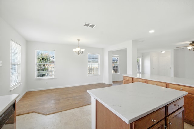 12430 Ridgetop Cir, Frisco, TX 75035 - kitchen with a chandelier, open floor plan, a center island, ceiling fan, and decorative light fixtures