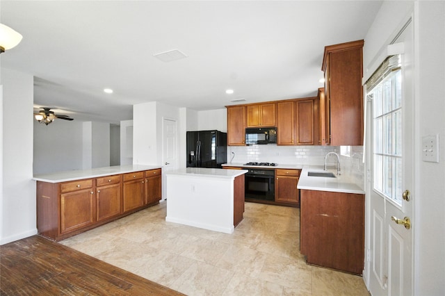 12430 Ridgetop Cir, Frisco, TX 75035 - kitchen featuring black appliances, brown cabinets, backsplash, a center island, and light countertops