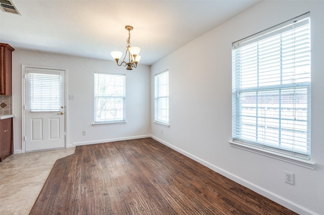 12430 Ridgetop Cir, Frisco, TX 75035 - unfurnished dining area with a chandelier and light wood-type flooring