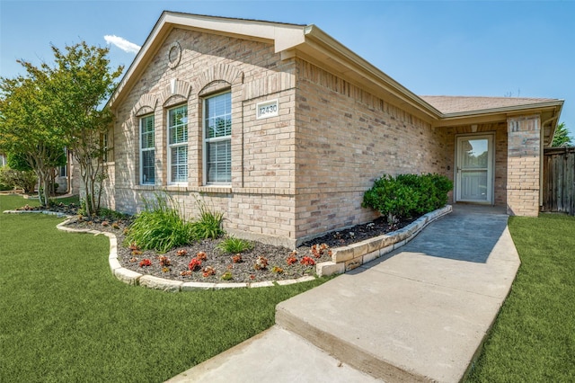 12430 Ridgetop Cir, Frisco, TX 75035 - view of side of home featuring brick siding and a lawn