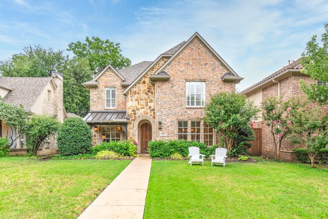 6154 Vickery Blvd, Dallas, TX 75214 - view of front of home with a front lawn, brick siding, a standing seam roof, and stone siding