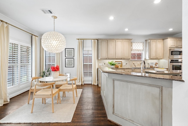 6154 Vickery Blvd, Dallas, TX 75214 - kitchen with stainless steel appliances, healthy amount of natural light, crown molding, dark stone countertops, and recessed lighting