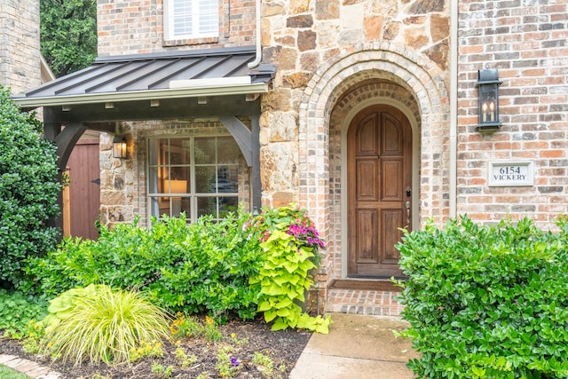 6154 Vickery Blvd, Dallas, TX 75214 - doorway to property featuring brick siding, a standing seam roof, and stone siding