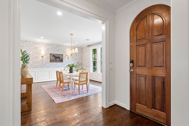 6154 Vickery Blvd, Dallas, TX 75214 - entryway featuring arched walkways, dark wood-style floors, ornamental molding, wallpapered walls, and a chandelier