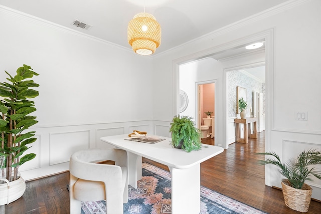 6154 Vickery Blvd, Dallas, TX 75214 - dining area with a decorative wall, crown molding, dark wood-type flooring, and wainscoting