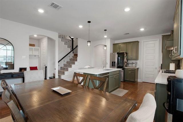 11504 Dawn Mist Dr, Frisco, TX 75035 - dining space with arched walkways, dark wood-style floors, stairs, and recessed lighting