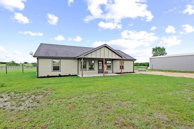 293 Private Road 36008, Honey Grove, TX 75446 - rear view of property featuring a yard, board and batten siding, dirt driveway, roof with shingles, and a patio