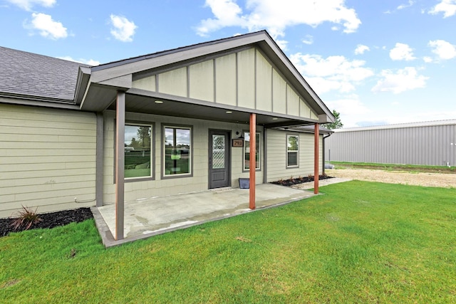 293 Private Road 36008, Honey Grove, TX 75446 - back of property with board and batten siding, a lawn, and a shingled roof