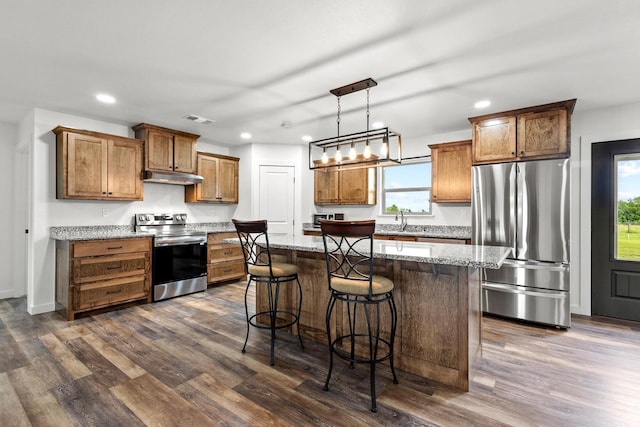 293 Private Road 36008, Honey Grove, TX 75446 - kitchen featuring appliances with stainless steel finishes, under cabinet range hood, recessed lighting, a kitchen island, and dark wood finished floors