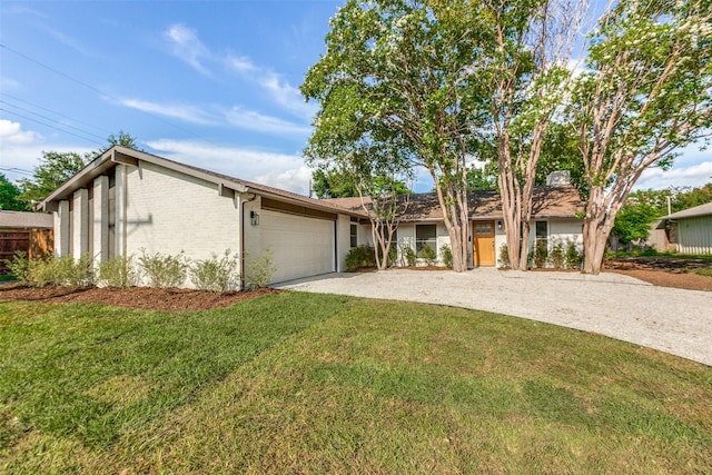 1508 N Waterview Dr, Richardson, TX 75080 - mid-century inspired home featuring driveway, a front lawn, an attached garage, and brick siding