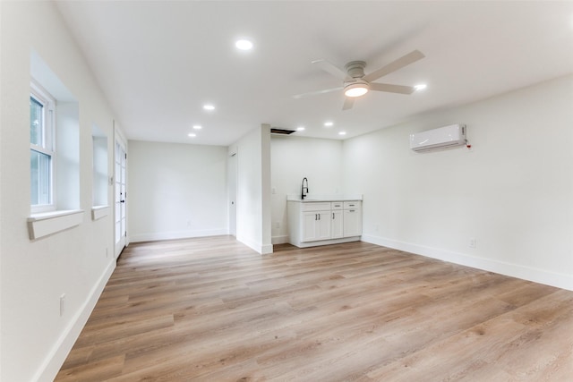 1508 N Waterview Dr, Richardson, TX 75080 - spare room with a wall mounted air conditioner, a ceiling fan, recessed lighting, and light wood-style flooring