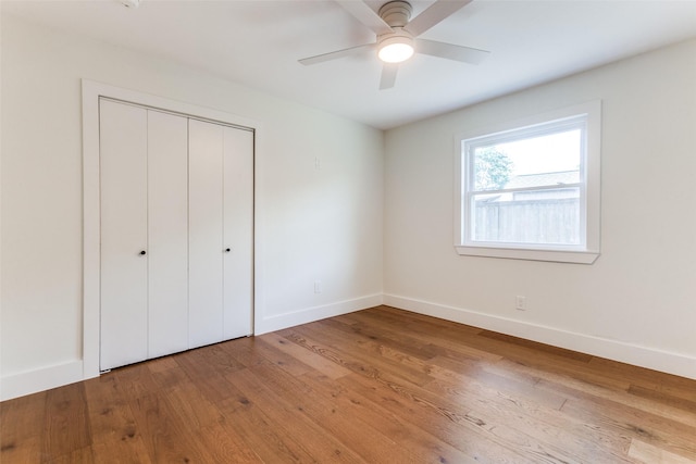 1508 N Waterview Dr, Richardson, TX 75080 - unfurnished bedroom with wood finished floors, a closet, and ceiling fan
