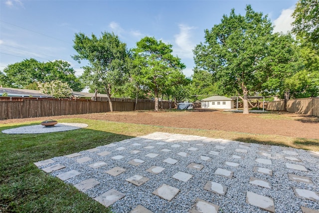 1508 N Waterview Dr, Richardson, TX 75080 - fenced backyard with an outdoor fire pit, an outdoor structure, and a patio area