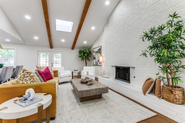1508 N Waterview Dr, Richardson, TX 75080 - living room featuring a skylight, a fireplace, wood finished floors, recessed lighting, and french doors