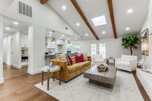 1508 N Waterview Dr, Richardson, TX 75080 - living room featuring a skylight, light wood finished floors, and recessed lighting