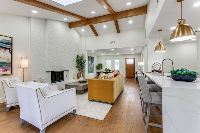 1508 N Waterview Dr, Richardson, TX 75080 - living area with high vaulted ceiling, light wood finished floors, recessed lighting, beam ceiling, and a fireplace