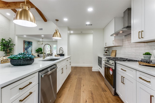 1508 N Waterview Dr, Richardson, TX 75080 - kitchen with stainless steel appliances, wall chimney exhaust hood, tasteful backsplash, light wood-style floors, and white cabinets