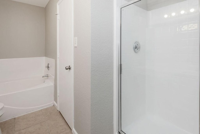 6119 Wall St, Arlington, TX 76018 - bathroom featuring a shower stall, a garden tub, tile patterned floors, and a textured wall
