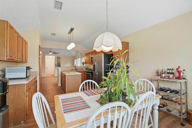 1801 Bent Brook Dr, Mesquite, TX 75181 - dining room featuring wood finished floors, ceiling fan, and vaulted ceiling