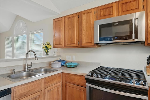 1801 Bent Brook Dr, Mesquite, TX 75181 - kitchen featuring stainless steel appliances, light countertops, lofted ceiling, and brown cabinets
